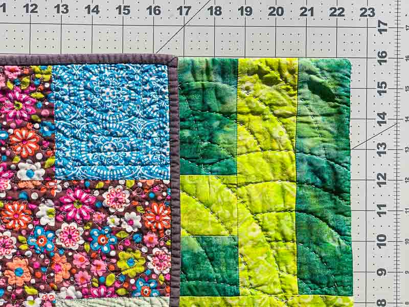 two quilts side by side showing the difference between traditional binding and a facing finish